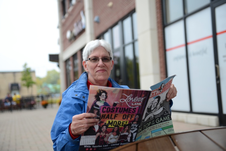 Mary Jo Durivage, a resident of West Dearborn, reads a paper outside of Common Grace Coffee, one of her favorite spots along Michigan Avenue. 