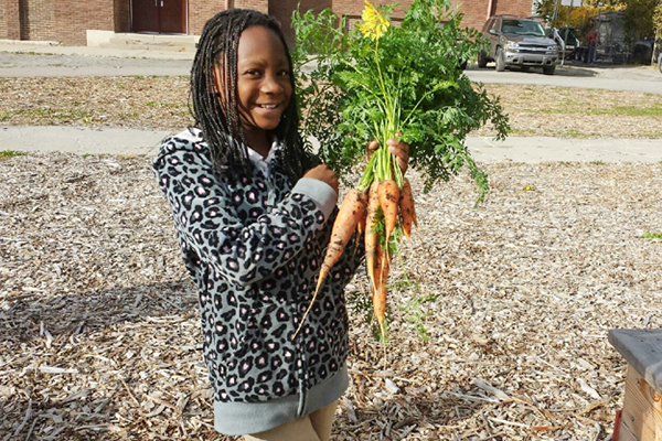 A young Detroiter at a youth garden