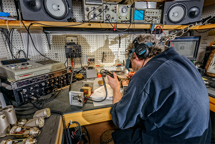 A technician repairing equipment at Vintage King Audio in Ferndale