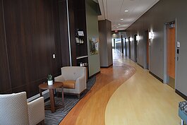 The hallway leading to patient rooms features a domestic vibe to aid in stress reduction during medical visits.