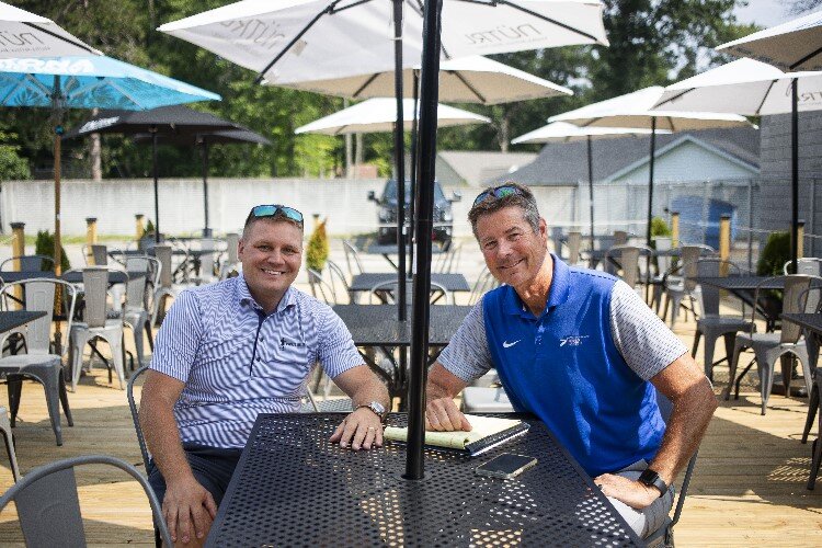 Frick's Sports Bar Co-owners Kurt Busard, left, and Jeff Rekeweg, sit for a portrait on the back patio.