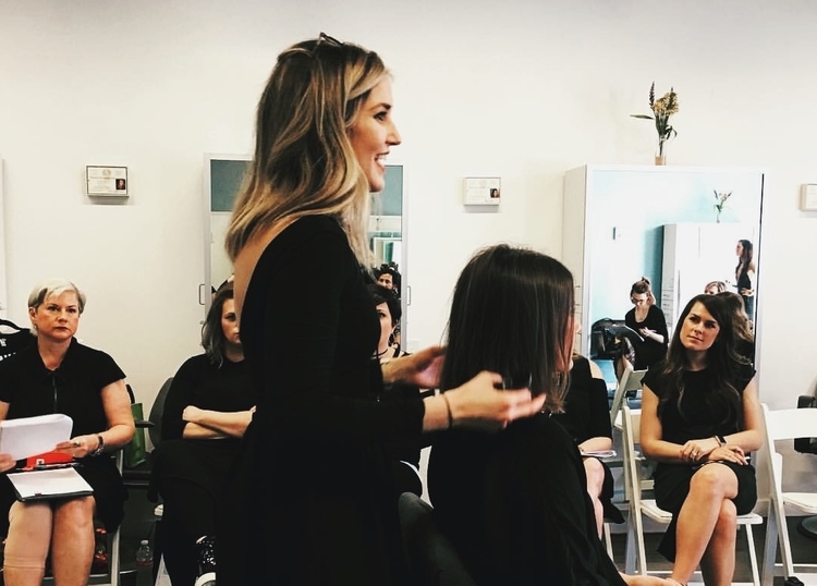 Mason teaching a class to other stylists