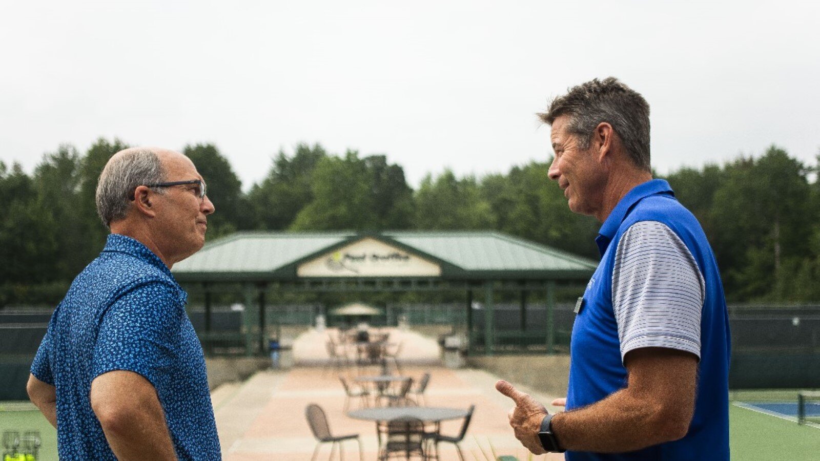 Greater Midland Tennis Center Executive Director Jeff Rekeweg, right, gives a tour of the facility to Eric Ward, commissioner of the Wolverine-Hoosier Athletic Conference.