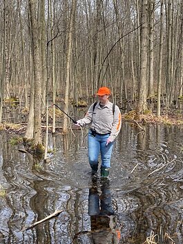 Field technician treats standing water.