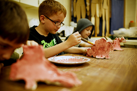 Mill Creek second-graders apply glaze to their pottery projects.