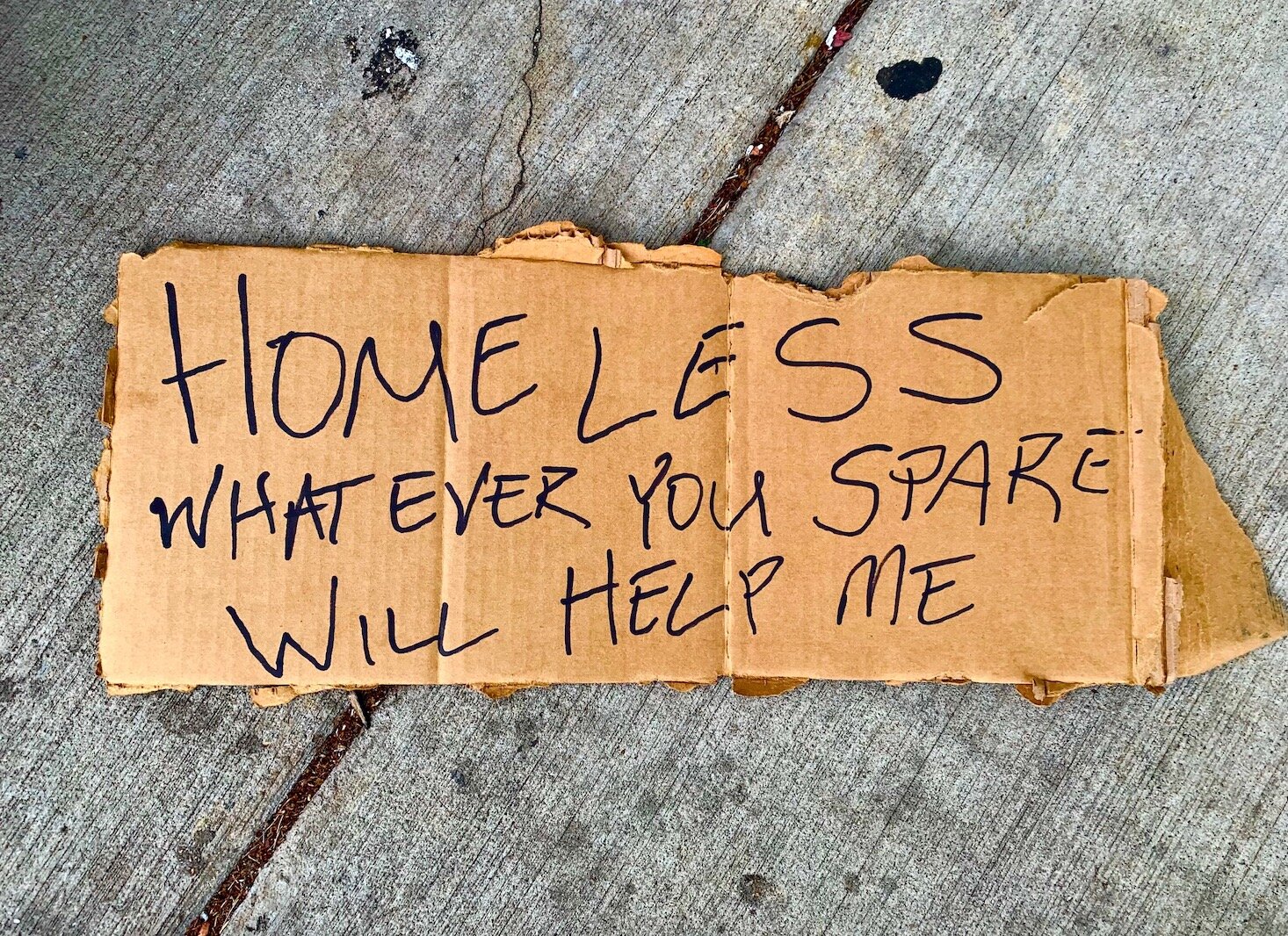 A community advocate for those facing substance abuse says signs that homeless people use to ask for help should be met with compassion.