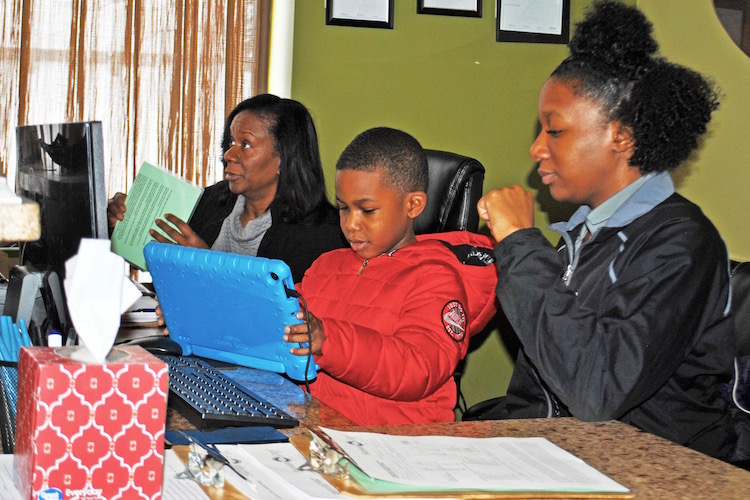 Margaret Kirk, her daughter, Spa Manager, Tyla Wade, and grandson, Arion Eppinger, use their new computer network made possible by a loan from the Small Business Community Loan and Grant Fund.
