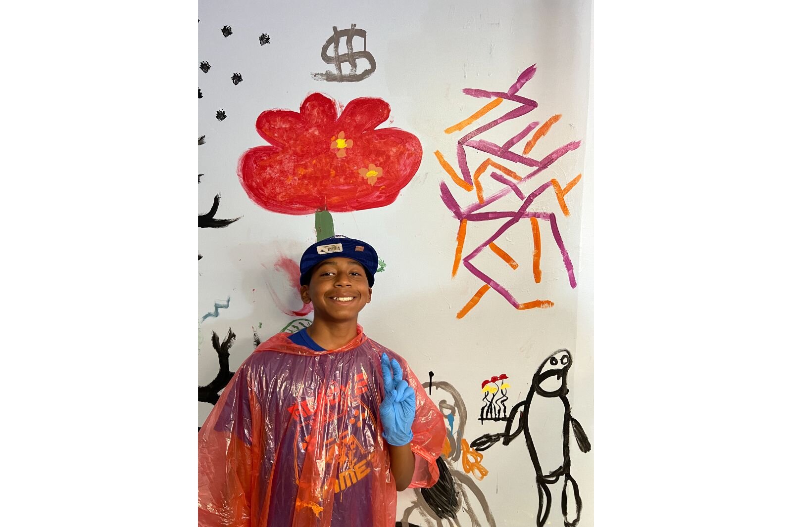 Chrus Wright poses in front of his part of the collaborative mural.