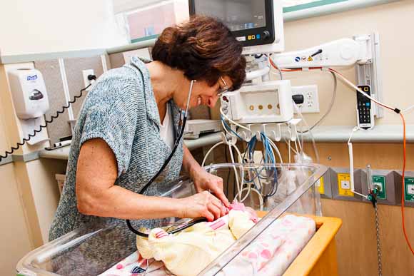 Bronson Neonatologist, Robin Pierucci, MD, examines baby