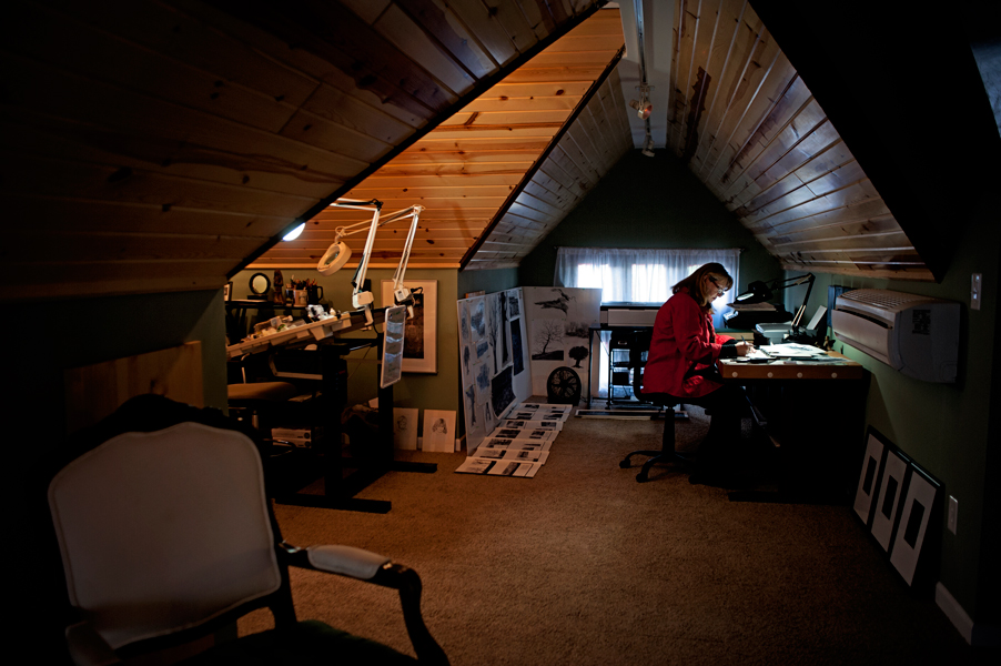 Linda Rzoska, owner of Ninth Wave Studio, works in her upstairs studio. 