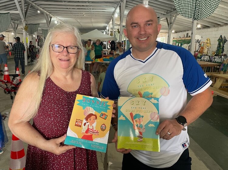 Mickey Carolan with his mom, Bonnie, holding the two books inspired by his parents.