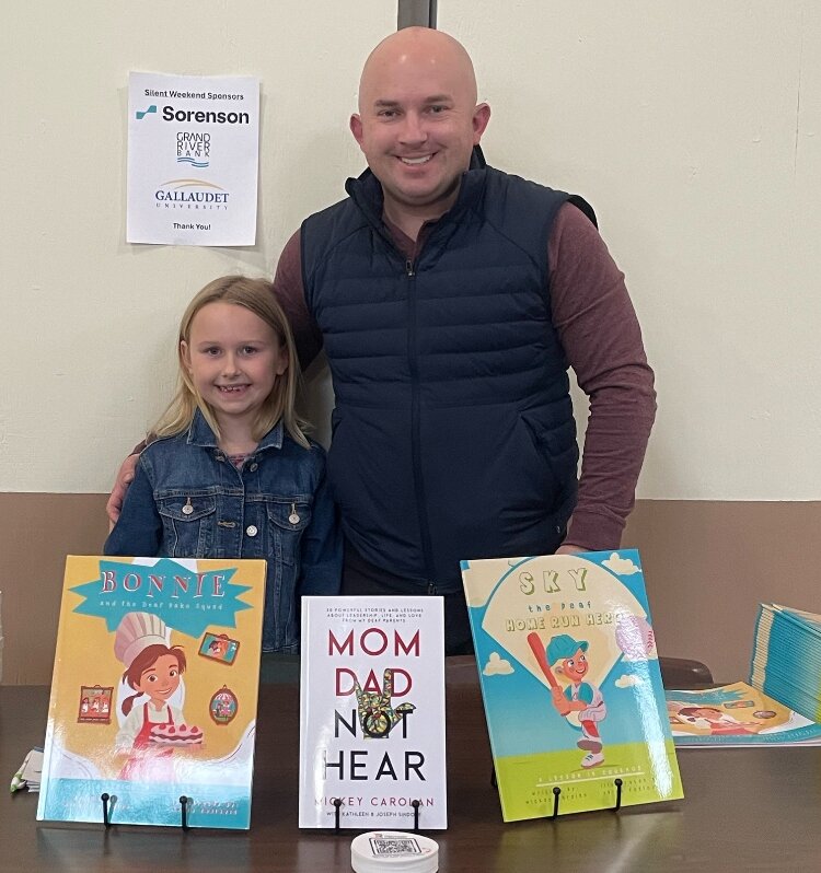 Mickey Carolan with his daughter, Elloree, and his three books.