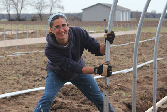Ruthie Thompson installs the first of five hoop houses in 2013.