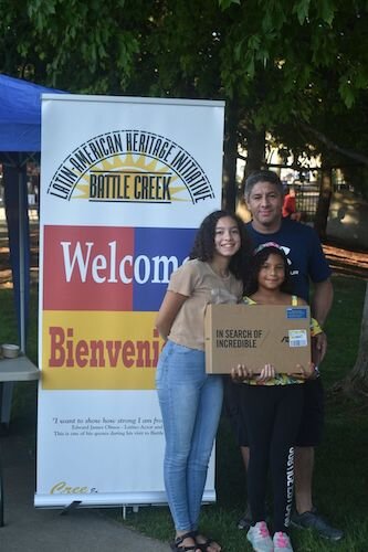 Santo Diaz and his children pose with a computer they received as part of a computer giveaway through the Battle Creek Latin American Heritage Initiative.  Diaz was one of 12 recipients of the computer giveaway.