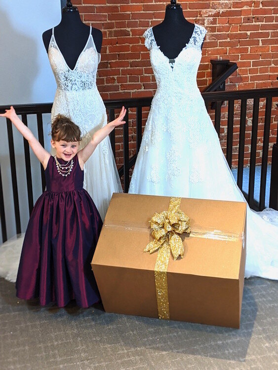 The very first Memories Bride Box is ready to go out to its bride. Piper Wissner, the 3-year-old daughter of shop owners Adrienne and Derek Wissner, presents the box.