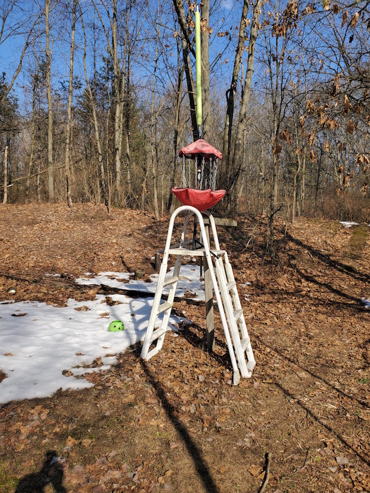 A raised disc golf basket on Hole 5 supported by a ladder will eventually sit on a pole.