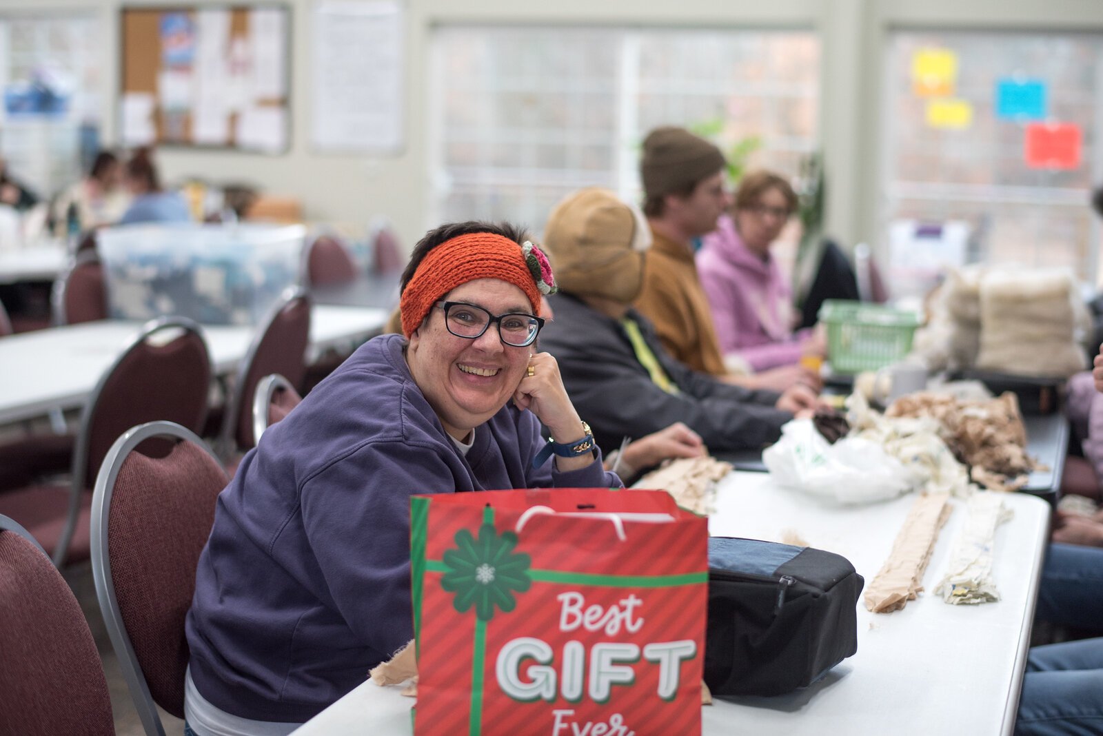 Teams of residents, participants, and volunteers skirt and wash the wool and alpaca fiber, operate the looms and carding machines and make wool dryer balls, cat toys, banners, potholders, wool scarves, bags, and other products.