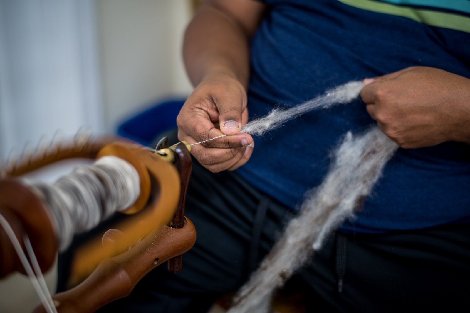 Residents and participants spin wool in the Woolery.