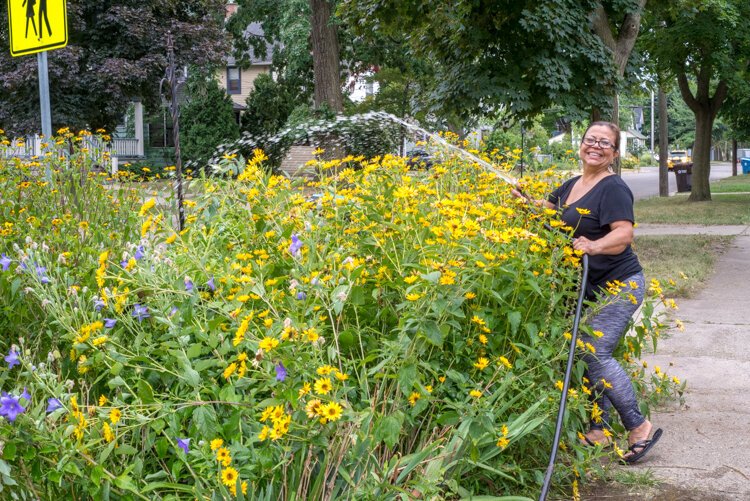 Martha Gonzalez, a longtime resident and avid gardener, enjoys spending time with her flowers and neighbors.