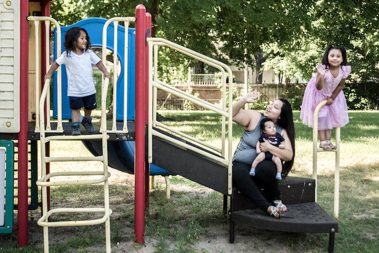 Perla Castenda is excited to learn of improvements planned for Reed Park since it is so close to where she and her children live. Photo by Fran Dwight.