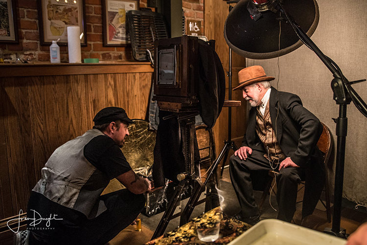 Photographer Fran Dwight catches Eric Hennig in action as he prepares a tintype.