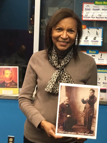 Bertha Barbee-McNeal, Artistic Director and Piano Teacher at the Helen Fox Gospel Music Center, holds a prized photo of Joseph Douglass, accomplished violinist and grandson of abolitionist Frederick Douglass after whom the Douglass Community Associat