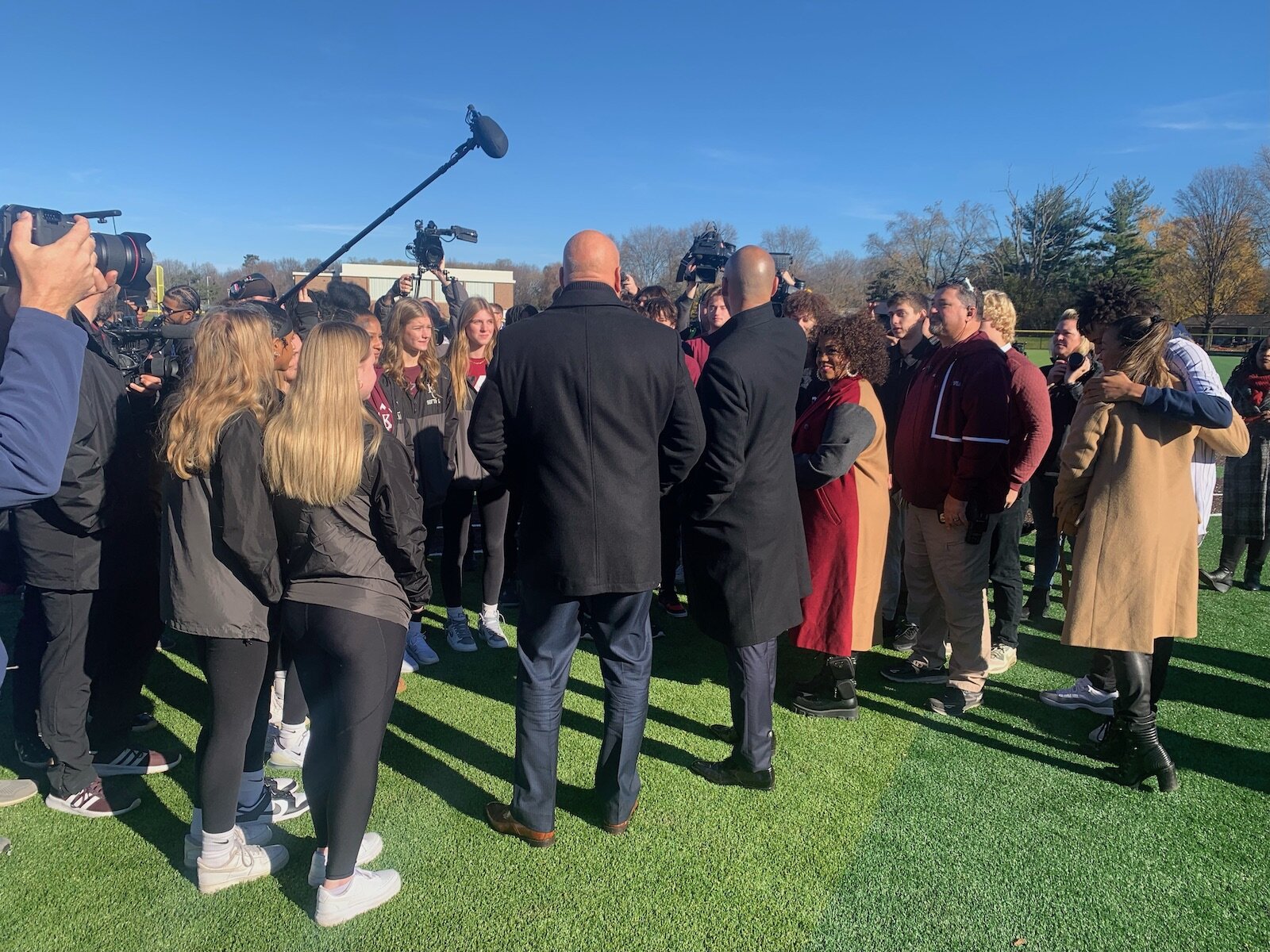 Cal Ripken Jr., left center, and Derek Jeter, center right, meet and answer a throng of students, school officials, and others during the Nov. 14, 2023 dedication of ball fields at Kalamazoo Central High School.