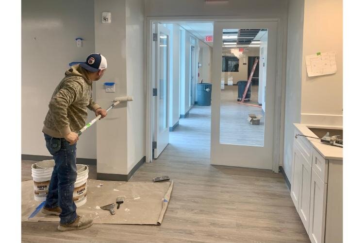 A worker paints a community room inside the new Enlightened Recovery treatment center in Kalamazoo on Monday, March 25, 2024. 