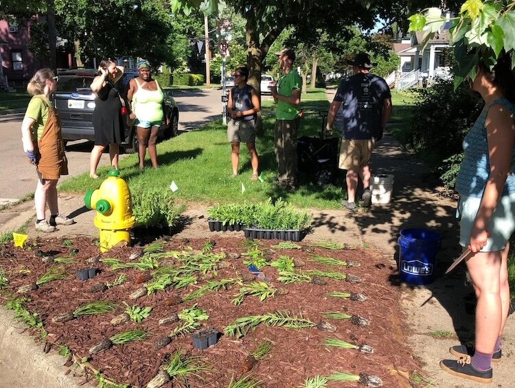 Vine Neighborhood residents prepare a small section of greenspace for planting in spring of a month of activities to celebrate Earth Day in 2022.