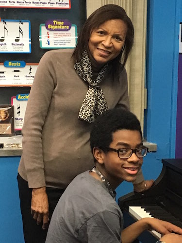 Bertha Barbee-McNeal, a founding Velvelette, teaches student Caleb Jackson, 12, at the Helen Fox Gospel Music Center.