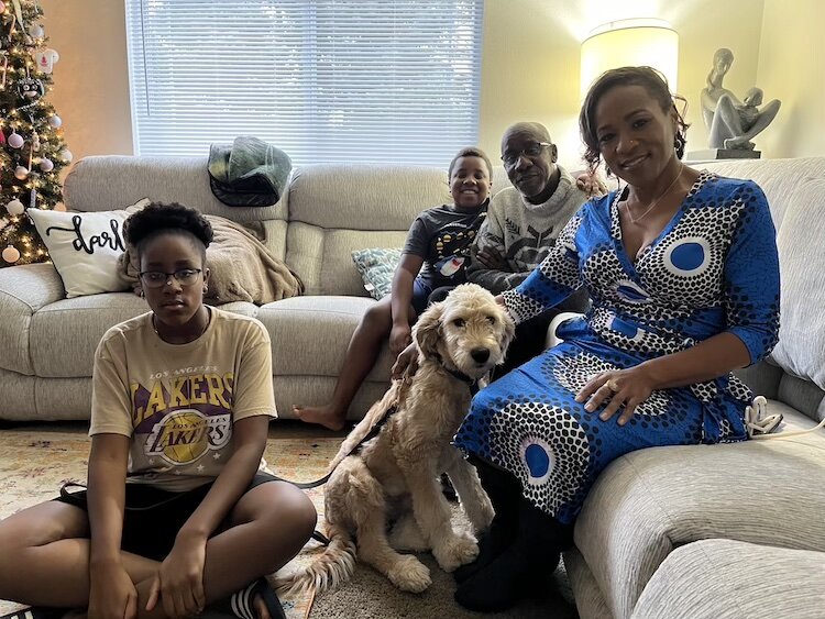  Maxwell and Jennifer Nkansah with their children, Sophiah and James, and their dog in the living room of their Portage home.