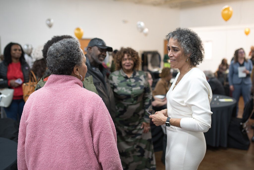 At right, Elizabeth Washington, new executive director of the NACD, meets neighborhood residents at a Friday, March 1, 2024 open house.