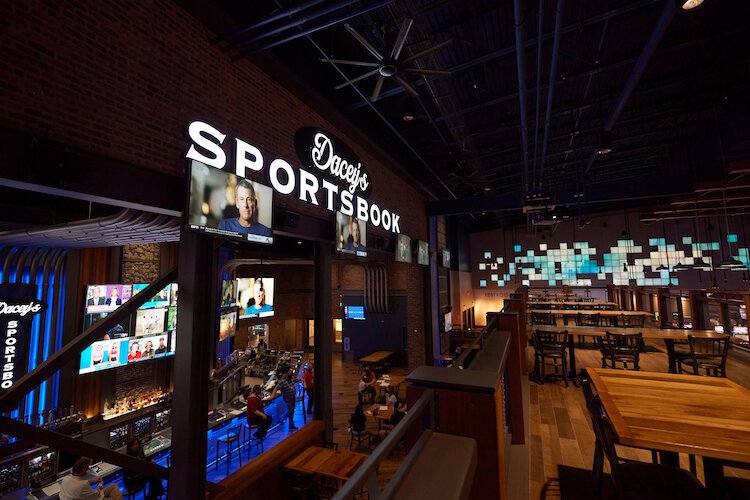 Patrons sit near the bar area at Dacey's Sportsbook and Taver