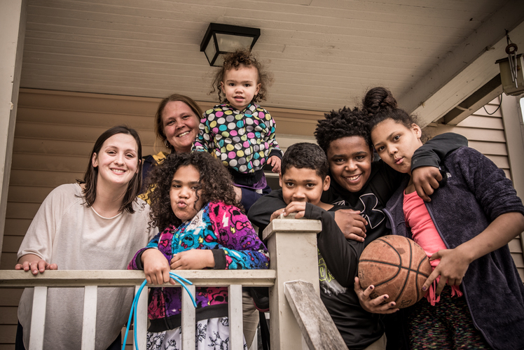 Nicole Miller gathers with Samantha Drew and her family at their home in the Edison neighborhood. Photo by Fran Dwight