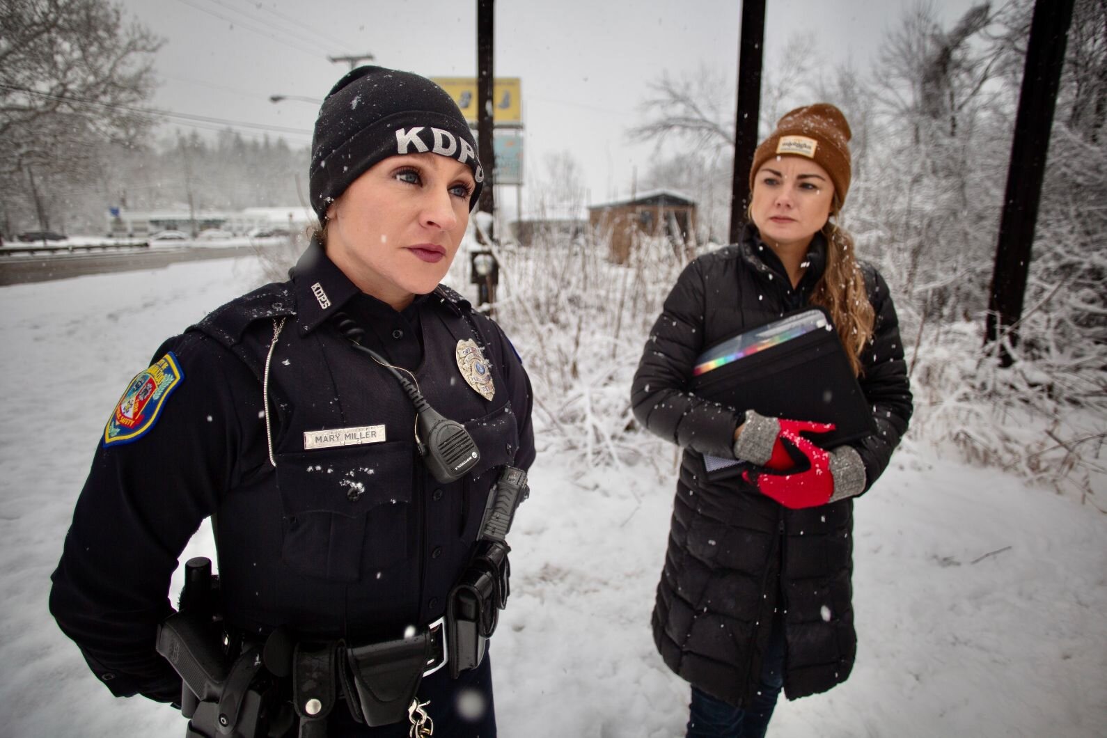 Kalamazoo Public Safety Officer Mary Miller, left, and Social Services Coordinator Kelsey Harness, prepare to check out a wooded area where unhoused people camped until recently on the city's East Side.
