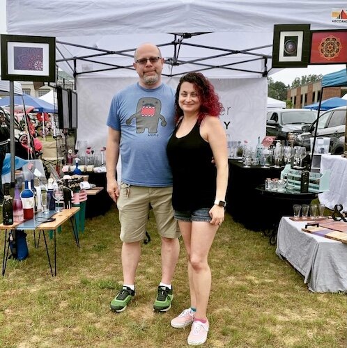 Matt and Jackie Chivell, shown in their exhibit booth last June at the Belding Beatnik Bazaar, started doing custom glass etchings and discovered Kzoo Makers when maker facilities in Grand Rapids shut down.