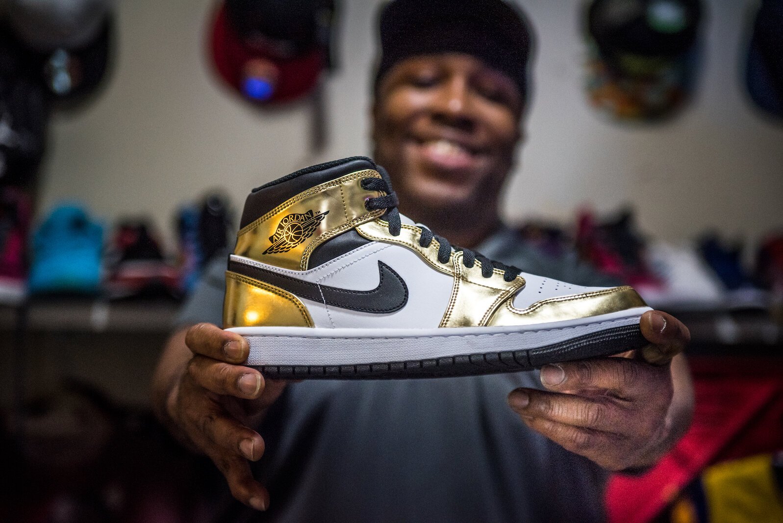 Roosevelt Lee-Fleming of Kalamazoo holds one of the sneakers that have been the focus of his business, The Drip Sneakers LLC.