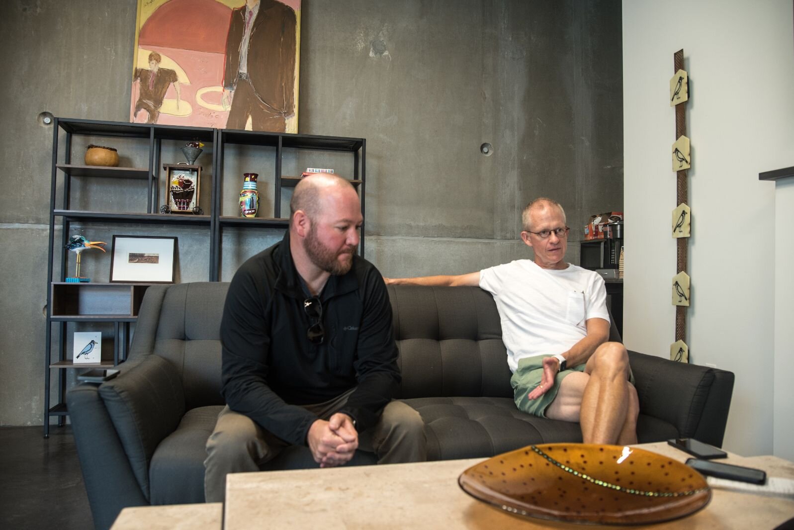 Garrett Seybert, left, and Jon Durham, right, sit in the lobby area of the Harrison Circle Apartments at 525 E. Ransom St. They are two of the four developers of the residential/commercial project.