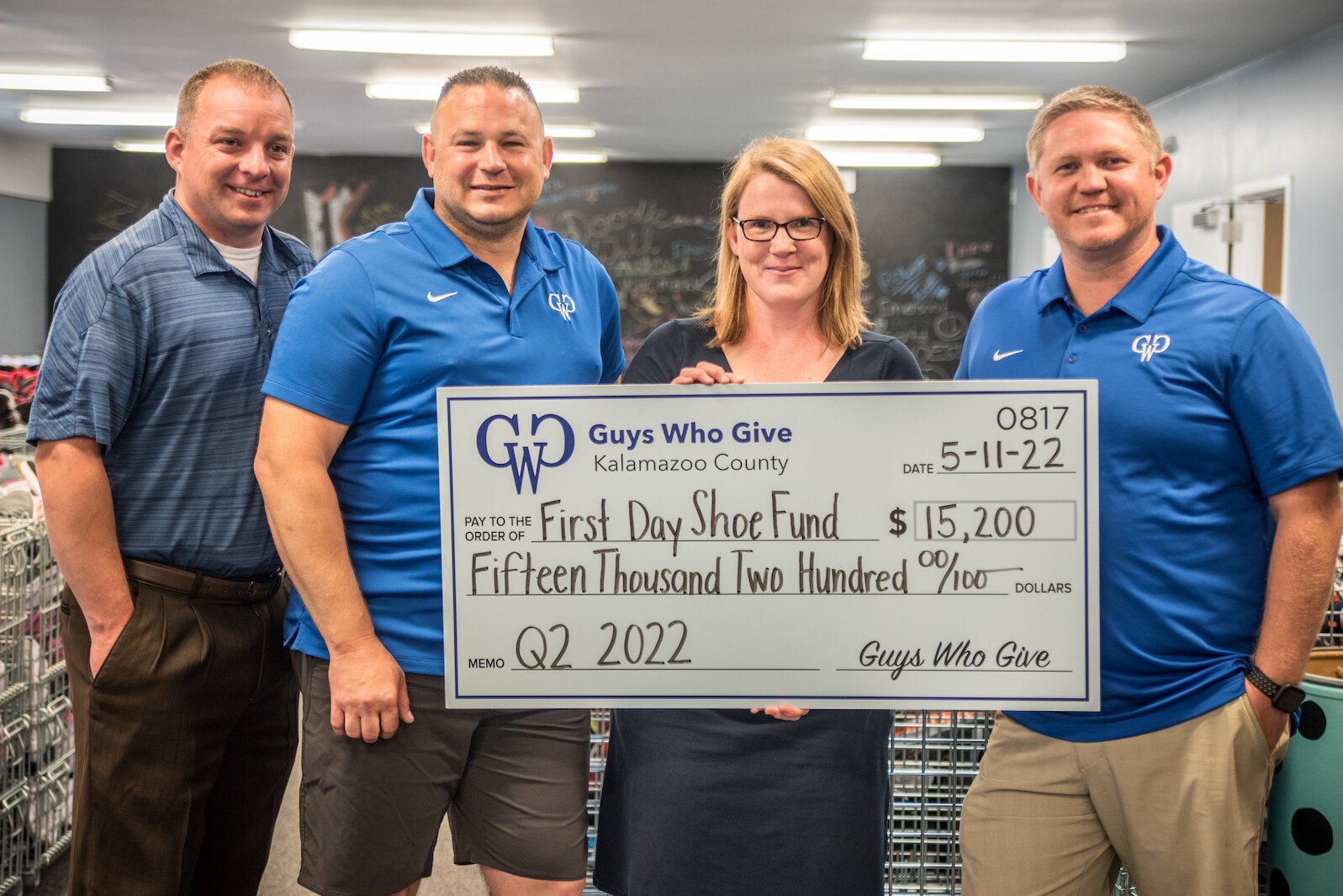 Maggie Hesketh, executive director of First Day Shoe Fund,  receives a major gift on Wednesday, June 22, 2022, from members of Guys Who Give. From left, they are Tim Evans, Don Solesbee, and Cody Livingston.