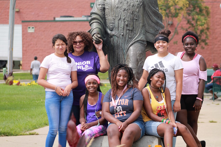Pam Roland and a group of participants in Kalamazoo Junior Gilrs Organization camp at the Martin Luther King Jr. Memorial Park 