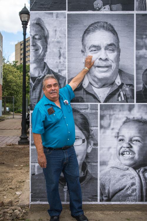 An Edison resident admires his photo on the wall of the former Color Lab. Photo by Fran Dwight