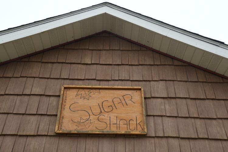 Sign over the doors at the front of the sugar shack.