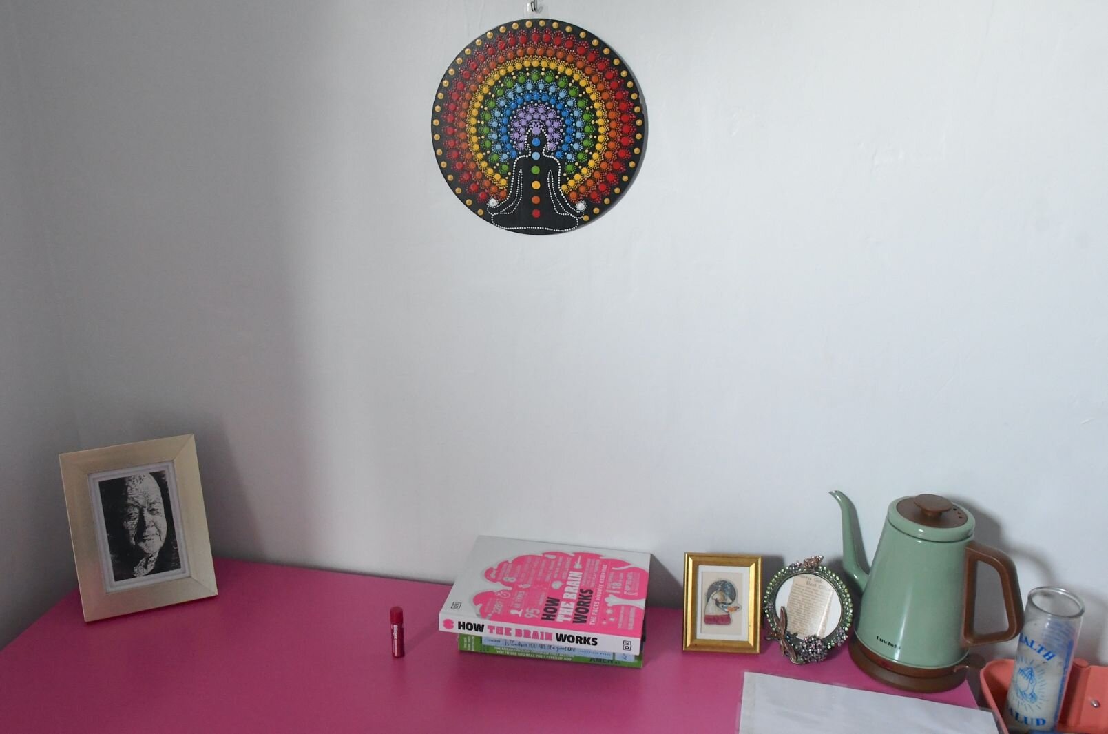 Kelley Climie’s desk has a mandala above it and a portrait of Kyoun Sokuzan, to the left, the founding Abbot of Sokukoji Buddhist Temple Monastery in Battle Creek