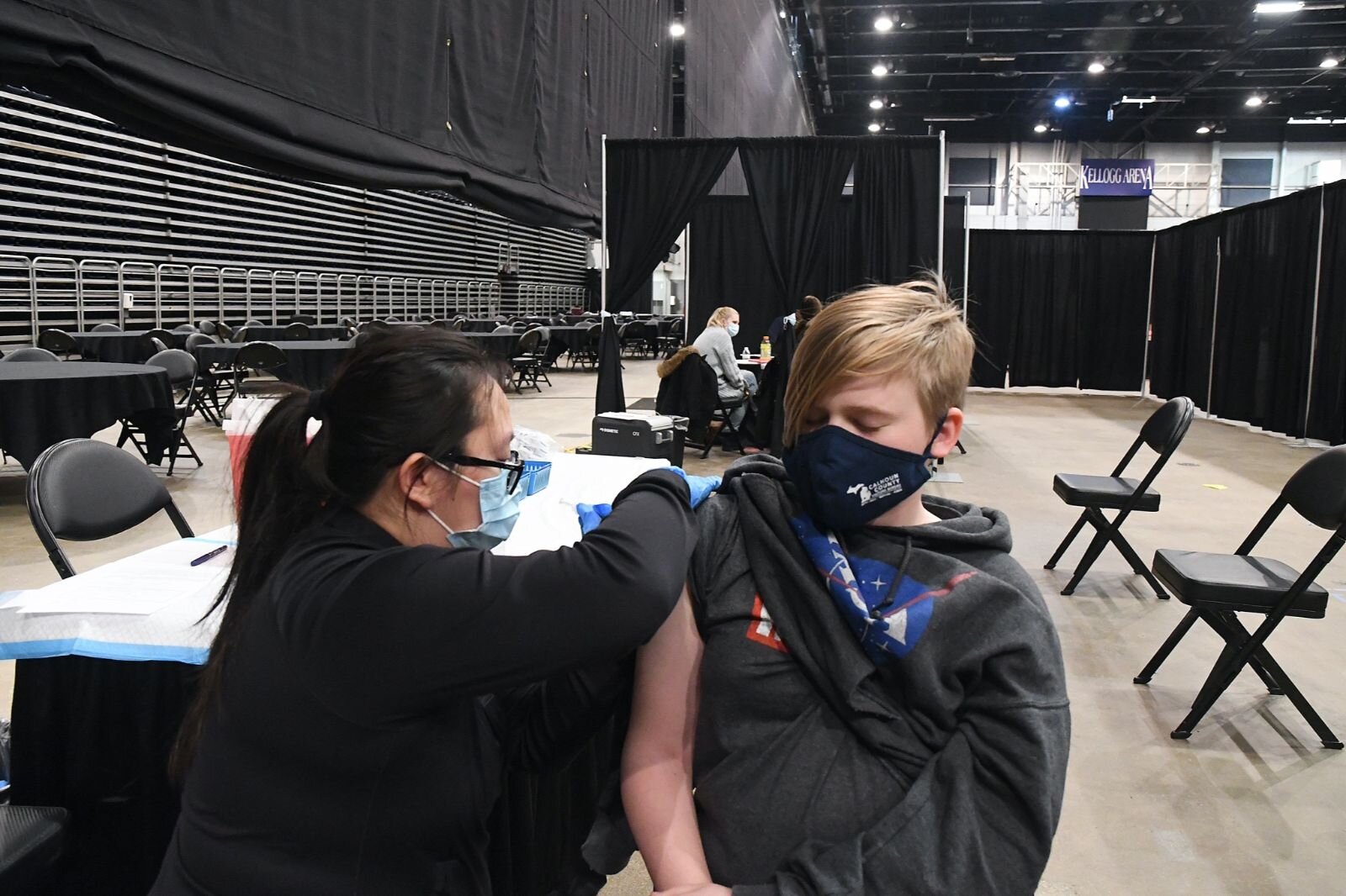 n this file photo from earlier this year George Pyatt, 13, receives a Pfizer COVID vaccine booster in Kellogg Arena.