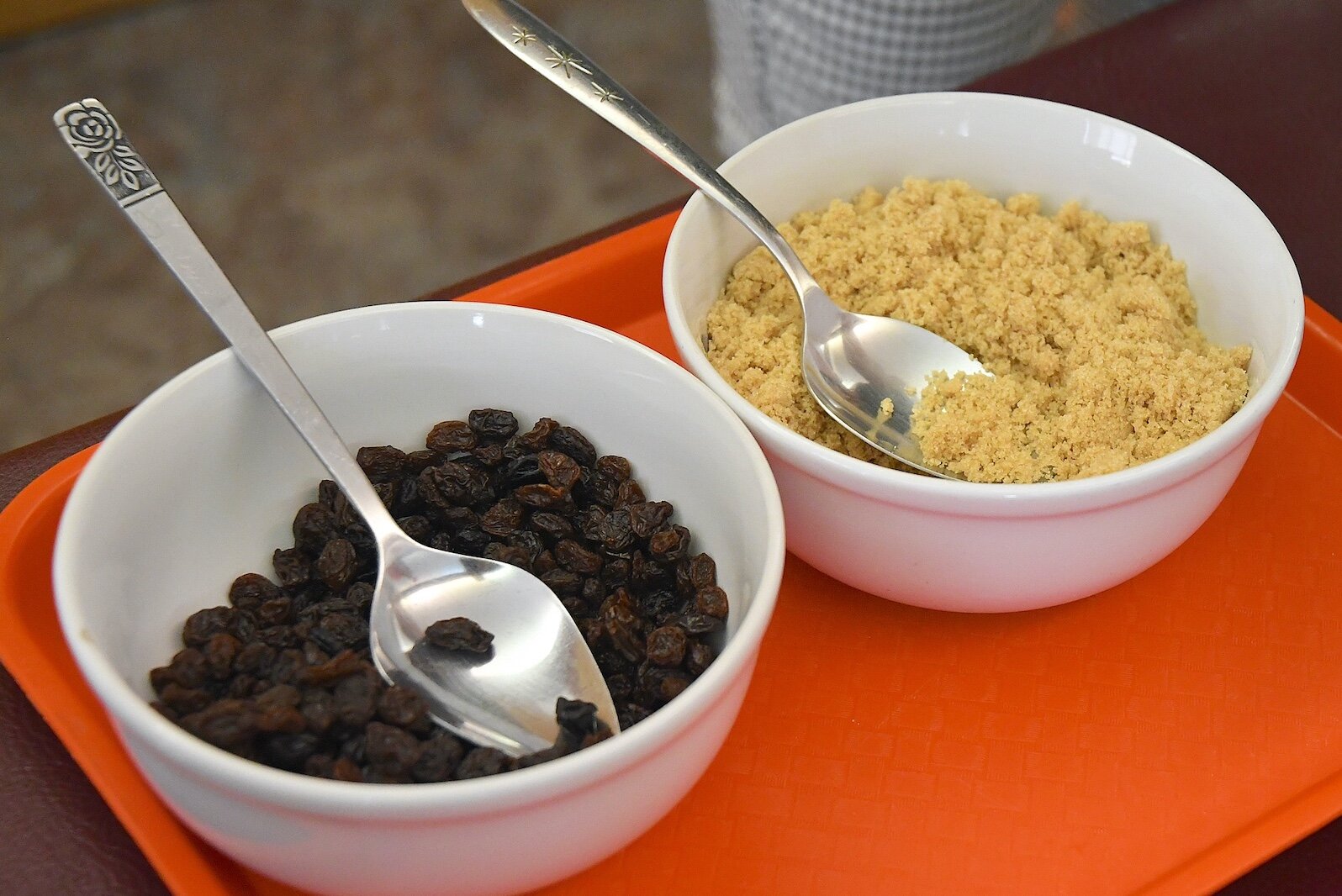Raisins and brown sugar are available to mix with oatmeal at St. Thomas Episcopal Church’s breakfast program.