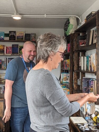 Laura Webb stopped by to check out the books for sale in Tom Batterson’s cargo container shop, New Story Community Books. 