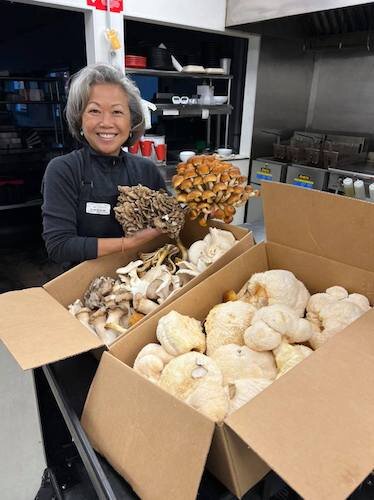 Peecoon Allen unpacks a delivery of mushrooms for her restaurant Umami Ramen.