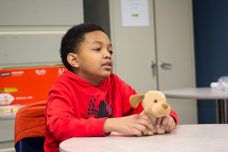 A stuffed puppy dog has a role in the fourth and fifth grade classroom of the after school program at New Genesis.