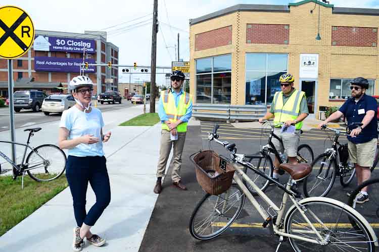 City Planning Director Rebekah Kik shows off the new bike lane in front Bell’s in July.