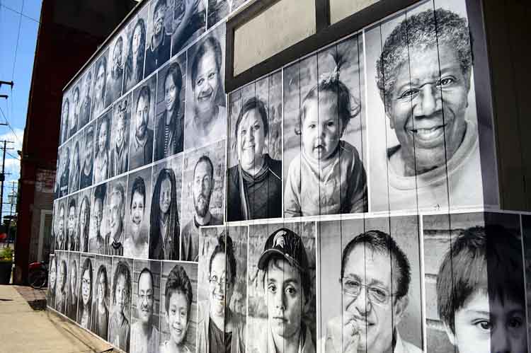 The faces of Edison residents cover much of the vacant Kalamazoo Color Lab. Photo by Mark Wedel